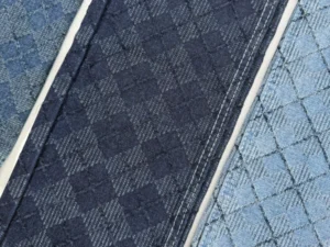 dark-wash-geometric-jacquard-denim-fabric-closeup.